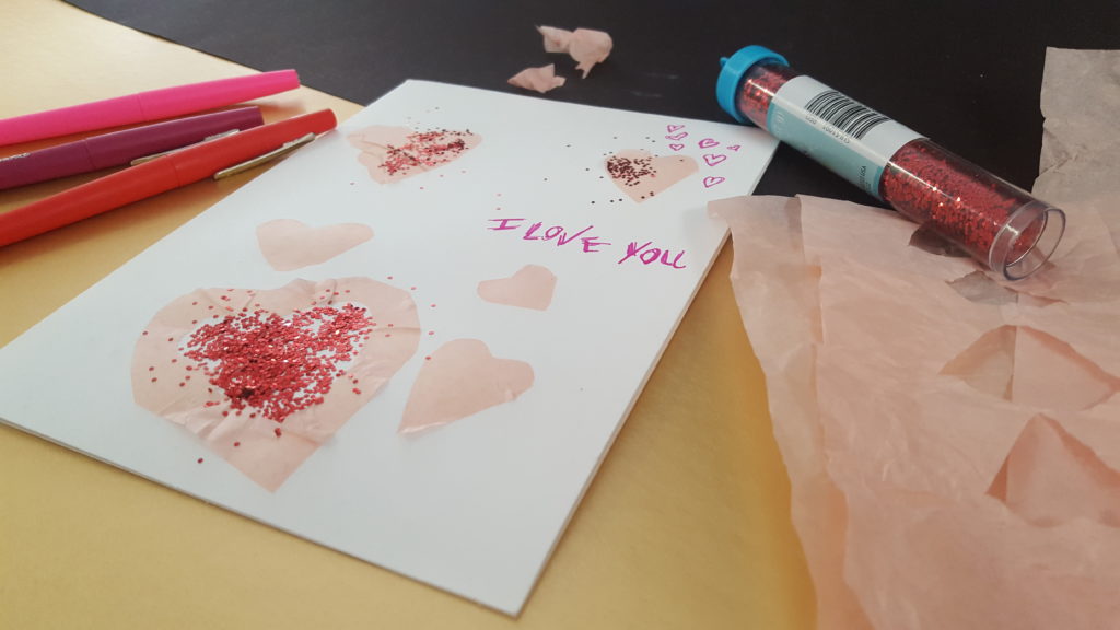 Kids DIY Valentines Card with cut-out hearts and red glitter