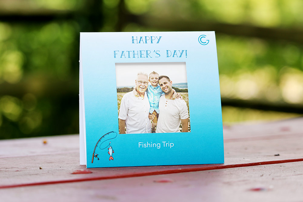 Father's Day Polaroid picture frame for a fishing trip. Frame is sitting outside on a red picnic table.