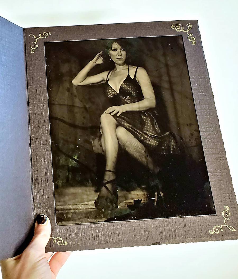 Large black studio portrait folder frames a tin type photo