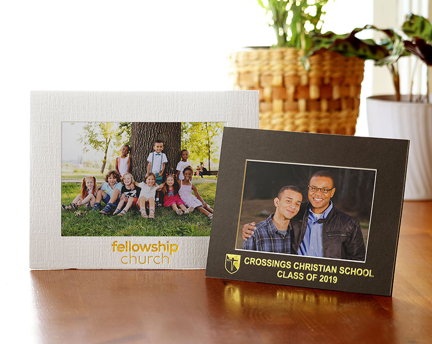 White and gray cardboard picture frames with church imprint in gold foil