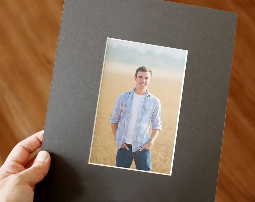 Gray picture frame mat holds a senior photo