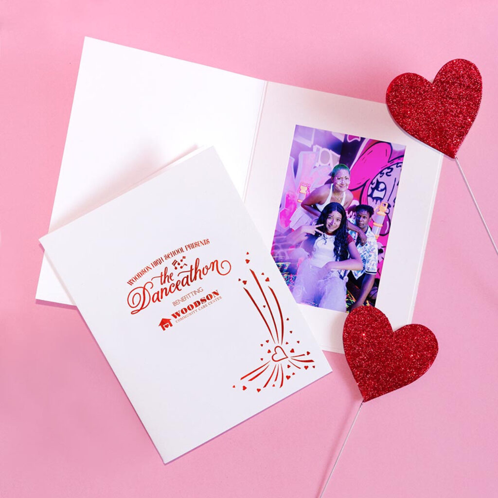 White photo folder with red foil heart design and fundraiser imprint on the front cover