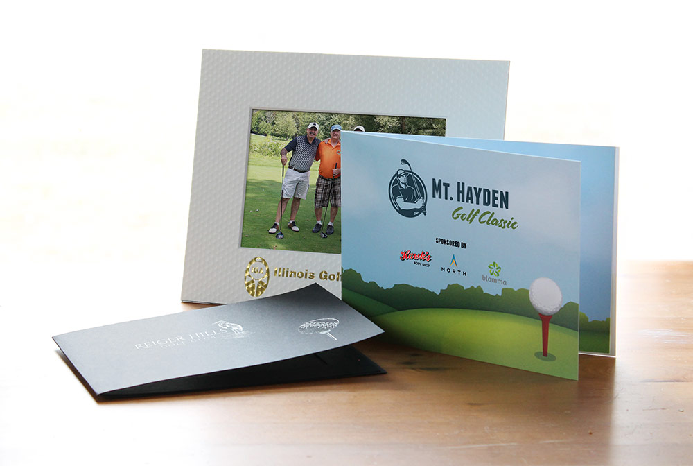 Black golf photo folder, custom printed golf course photo folder, and a white golf ball textured picture frame.