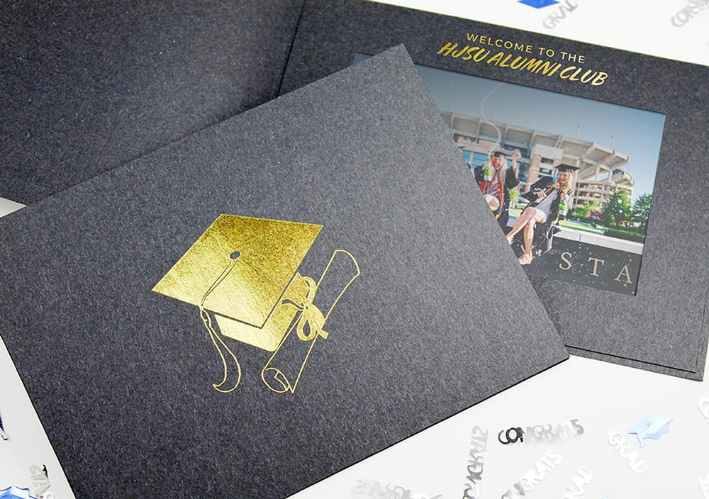 Black photo folder with gold foil graduation cap imprinted on the front cover and a personalized imprint on the window frame border.
