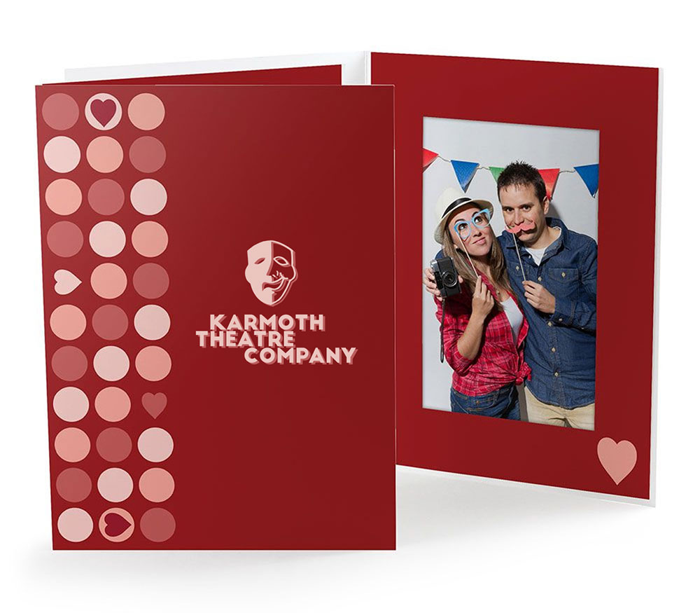 Red photo folder with a polka dot heart design has a theatre logo on the front cover.